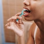 Woman flossing to keep her gums healthy — gum care from The Dental Ethics, Pune