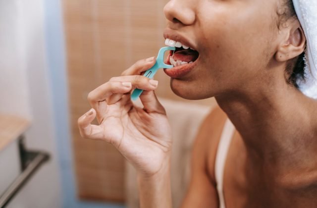 Woman flossing to keep her gums healthy — gum care from The Dental Ethics, Pune