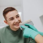 Dentist matching a tooth shade guide for professional teeth whitening at The Dental Ethics, Pune