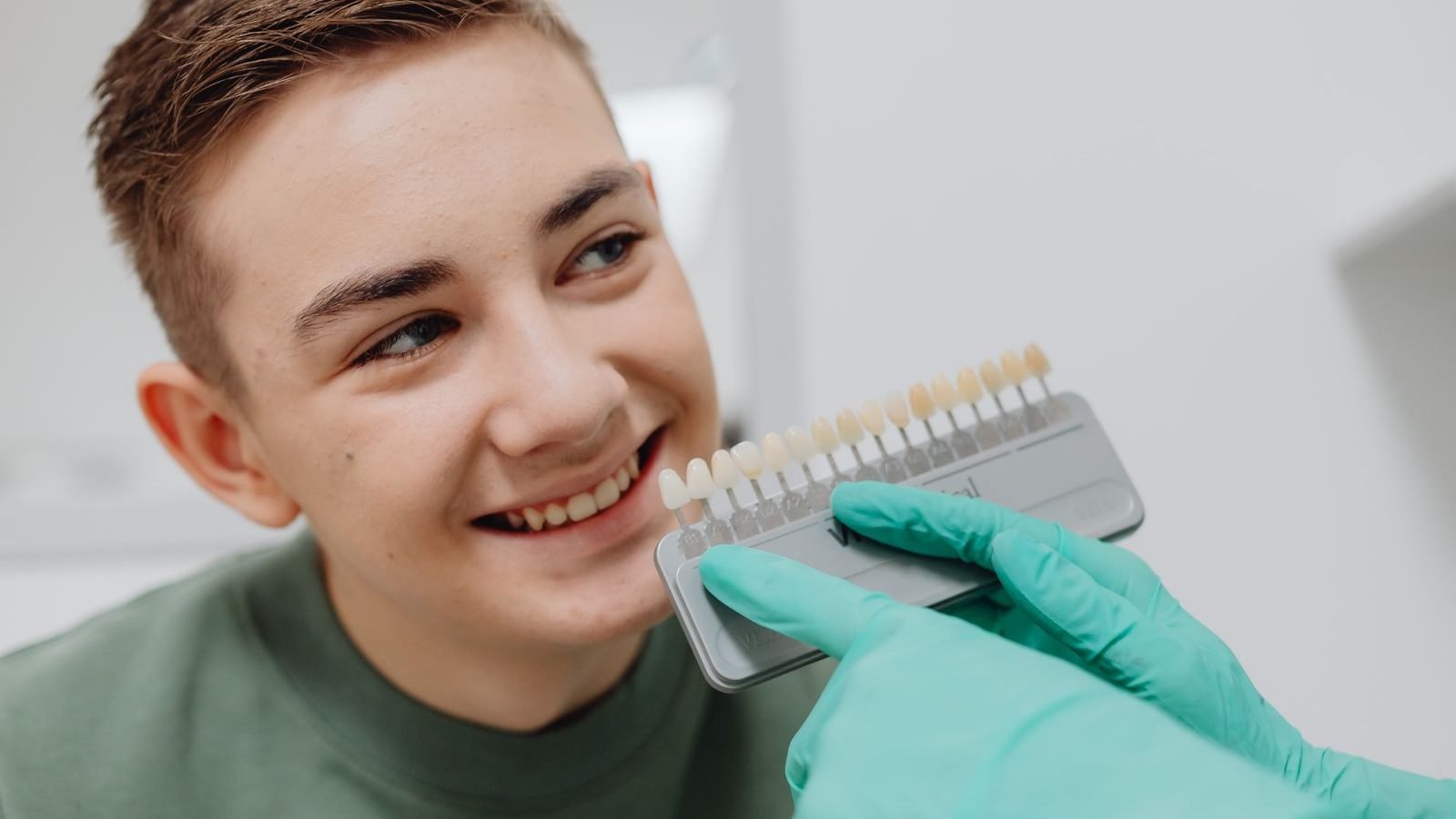 Dentist matching a tooth shade guide for professional teeth whitening at The Dental Ethics, Pune