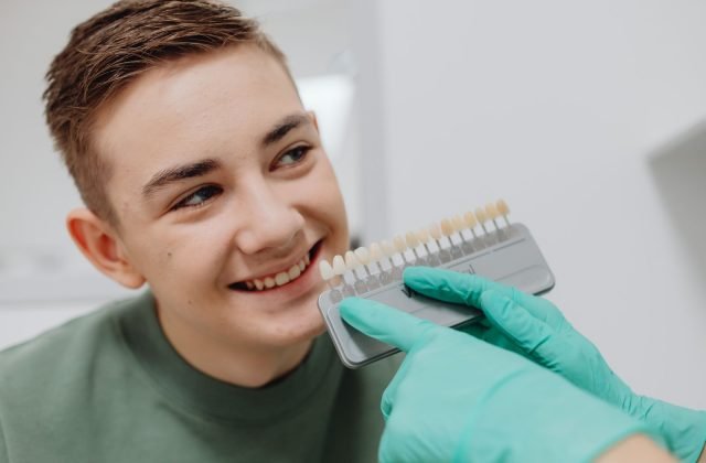 Dentist matching a tooth shade guide for professional teeth whitening at The Dental Ethics, Pune